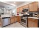 Kitchen showcasing stainless steel appliances and wood cabinets at 5978 Autumn Harvest Ave, Las Vegas, NV 89142