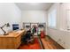 Cozy office space features a wooden desk, shelves, and plantation shutters at 5978 Autumn Harvest Ave, Las Vegas, NV 89142
