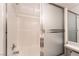 Close-up of the bathtub with shower, showcasing the tiling and frosted-glass sliding door at 5978 Autumn Harvest Ave, Las Vegas, NV 89142