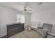 Bedroom with crib, dresser, and comfortable armchair at 6128 Casper Sands Ct, North Las Vegas, NV 89031