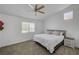 Spacious bedroom features a ceiling fan, neutral colors, and comfortable carpeting at 6128 Casper Sands Ct, North Las Vegas, NV 89031