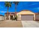 Charming single-story home with a desert landscape, tile roof, and a two-car garage at 6128 Casper Sands Ct, North Las Vegas, NV 89031