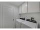 Laundry room with washer, dryer, and storage cabinets at 6128 Casper Sands Ct, North Las Vegas, NV 89031