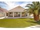 Backyard featuring artificial turf, covered patio, and mature landscaping at 6222 Eliza Ln, North Las Vegas, NV 89031