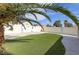 Backyard featuring artificial turf, block wall, and mature landscaping at 6222 Eliza Ln, North Las Vegas, NV 89031