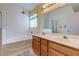 Bright bathroom featuring a soaking tub, a glass-enclosed shower, and a double vanity at 6222 Eliza Ln, North Las Vegas, NV 89031