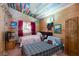 Unique bedroom featuring two beds, wood paneled walls and ceiling, and colorful accents at 6222 Eliza Ln, North Las Vegas, NV 89031