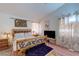 Cozy bedroom with natural light, carpet, and a decorative bedframe at 6222 Eliza Ln, North Las Vegas, NV 89031