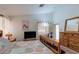 Bright bedroom with natural light, a wood dresser, and access to the bathroom at 6222 Eliza Ln, North Las Vegas, NV 89031