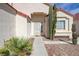 Front entrance with a desert landscape, security door and walkway to the front door at 6222 Eliza Ln, North Las Vegas, NV 89031