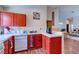 Cozy kitchen with wood floors, red cabinets, and white appliances at 6222 Eliza Ln, North Las Vegas, NV 89031