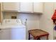 Practical laundry room with a white washing machine and wood side table at 6222 Eliza Ln, North Las Vegas, NV 89031