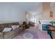 Open living room with a cozy fireplace, plush sofas, and carpet flooring at 6222 Eliza Ln, North Las Vegas, NV 89031