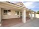 Wide angle view of the covered patio with brick flooring and exterior access at 6222 Eliza Ln, North Las Vegas, NV 89031