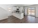 Modern kitchen featuring stainless steel appliances, a peninsula island, and hardwood flooring at 6270 Blood Lily Ave, Las Vegas, NV 89122