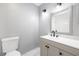 Tasteful bathroom with modern vanity, mirror, lighting, and toilet; refined fixtures enhancing its charm at 6442 Ironbark Ln, Las Vegas, NV 89107
