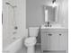 Cozy bathroom featuring a tub-shower combo with neutral vanity, toilet and a mirrored medicine cabinet at 6442 Ironbark Ln, Las Vegas, NV 89107