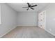 Clean bedroom featuring hardwood floors, ceiling fan and a single door, offers a serene setting at 6442 Ironbark Ln, Las Vegas, NV 89107
