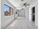 Light-filled bedroom with hardwood floors, ceiling fan and large mirrored closet, enhancing space and style at 6442 Ironbark Ln, Las Vegas, NV 89107