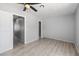 Neutral toned bedroom with wood floors, offers a serene setting with two doors and a ceiling fan at 6442 Ironbark Ln, Las Vegas, NV 89107