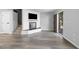 Bright living room showcasing a modern fireplace, hardwood style floors, and a view of the front entrance at 6442 Ironbark Ln, Las Vegas, NV 89107