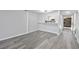 Living room featuring gray flooring and an open bar to the kitchen with new appliances at 6442 Ironbark Ln, Las Vegas, NV 89107