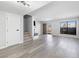Open living room featuring gray hardwood floors, a modern fireplace, and an abundance of natural light at 6442 Ironbark Ln, Las Vegas, NV 89107