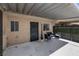Inviting covered patio with stylish furniture, offering an ideal outdoor area for relaxation and entertaining at 6442 Ironbark Ln, Las Vegas, NV 89107