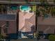 Aerial shot showcasing a backyard pool with lush landscaping and a tiled roof at 7125 Mountain Den Ave, Las Vegas, NV 89179