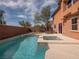 Inviting backyard pool and spa area with a private wall, patio furniture and tasteful landscaping at 7125 Mountain Den Ave, Las Vegas, NV 89179