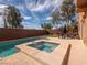 Backyard pool and spa with patio, desert landscaping, outdoor seating, and a private brick wall at 7125 Mountain Den Ave, Las Vegas, NV 89179