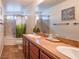 Bright bathroom featuring a double sink vanity, garden-style bathtub and stylish decor at 7125 Mountain Den Ave, Las Vegas, NV 89179