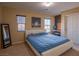 Inviting bedroom with large windows, a cozy bed, and ample natural light for a restful ambiance at 7125 Mountain Den Ave, Las Vegas, NV 89179