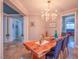 Elegant dining space featuring a live edge table, designer chandelier, and classic decor at 7125 Mountain Den Ave, Las Vegas, NV 89179