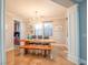 Bright dining room featuring live edge table, modern chandelier, and sleek stone flooring at 7125 Mountain Den Ave, Las Vegas, NV 89179