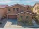 Charming two-story home featuring desert landscaping, a brick facade and a two-car garage at 7125 Mountain Den Ave, Las Vegas, NV 89179