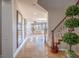 Beautiful hallway leading to a bright living space, featuring elegant mirrors and travertine flooring at 7125 Mountain Den Ave, Las Vegas, NV 89179