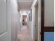 Hallway with neutral walls and carpeting, features doors leading to various rooms, and recessed lighting at 7125 Mountain Den Ave, Las Vegas, NV 89179