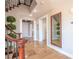 Elegant hallway featuring stone floors, classic staircase, and decorative plants at 7125 Mountain Den Ave, Las Vegas, NV 89179