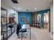Stylish home office showcasing blue walls, modern shelves, and an organized workspace at 7125 Mountain Den Ave, Las Vegas, NV 89179