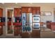 Gourmet kitchen with stainless steel appliances and elegant dark cherry wood cabinetry at 7125 Mountain Den Ave, Las Vegas, NV 89179
