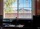 Close up of the kitchen sink and window with a mountain view at 7125 Mountain Den Ave, Las Vegas, NV 89179