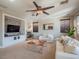 Spacious living room featuring a fireplace and a comfortable seating area with a ceiling fan at 7125 Mountain Den Ave, Las Vegas, NV 89179