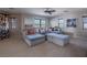 Bright and airy living room with a large sectional sofa, neutral tones, and ample natural light at 7125 Mountain Den Ave, Las Vegas, NV 89179