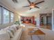 Bright living room with open floor plan, view of the kitchen, and comfortable furniture at 7125 Mountain Den Ave, Las Vegas, NV 89179