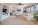 Bright living room features plush carpet, modern decor, and a cozy fireplace, perfect for relaxation at 7125 Mountain Den Ave, Las Vegas, NV 89179