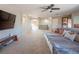 Open-concept living room with large sectional sofa, TV, and access to other rooms at 7125 Mountain Den Ave, Las Vegas, NV 89179