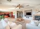 Bright, open-concept living room features modern decor, carpet, and adjacent gourmet kitchen at 7125 Mountain Den Ave, Las Vegas, NV 89179