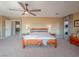 Comfortable main bedroom featuring an ensuite bathroom and bright light fixture at 7125 Mountain Den Ave, Las Vegas, NV 89179