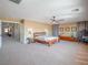 Large main bedroom with carpet, ceiling fan, bedside tables, and decorations at 7125 Mountain Den Ave, Las Vegas, NV 89179